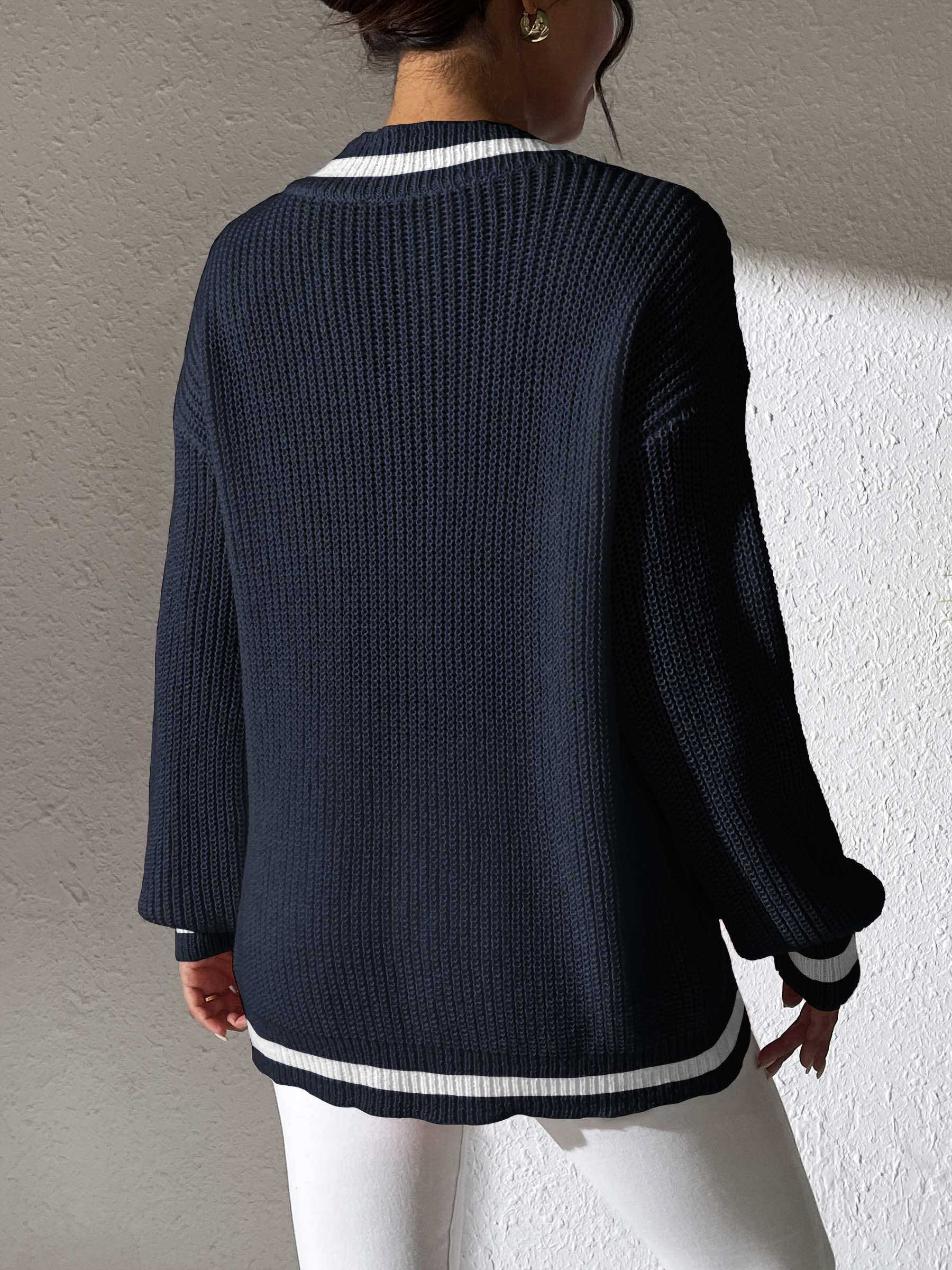 Dark navy knit sweater with white stripe trim at V-neck and hem.