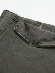 Grey wide-leg cargo pants with a visible flap pocket detail.