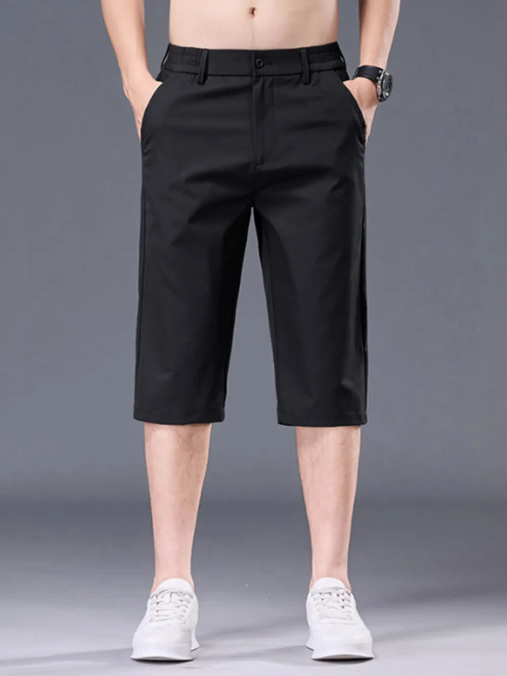 Black chino shorts for men with belt loops and pockets, casual knee-length style.