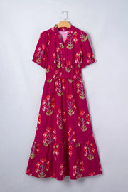 Charming floral tiered midi dress in magenta with red floral print, V-neck, short sleeves, and smocked waist.