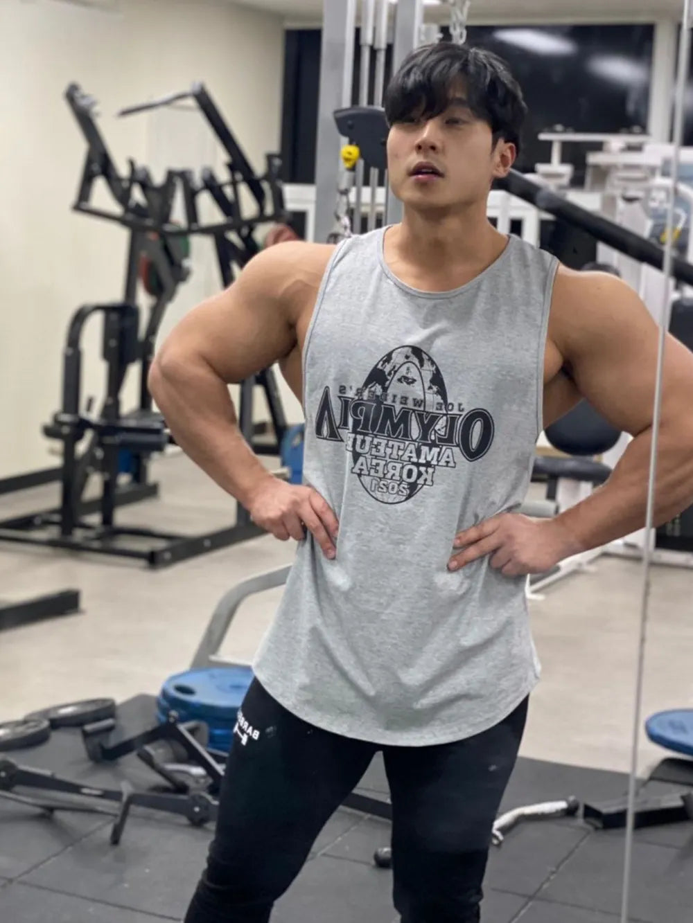 Gray graphic muscle tank top with a circular logo on the chest.