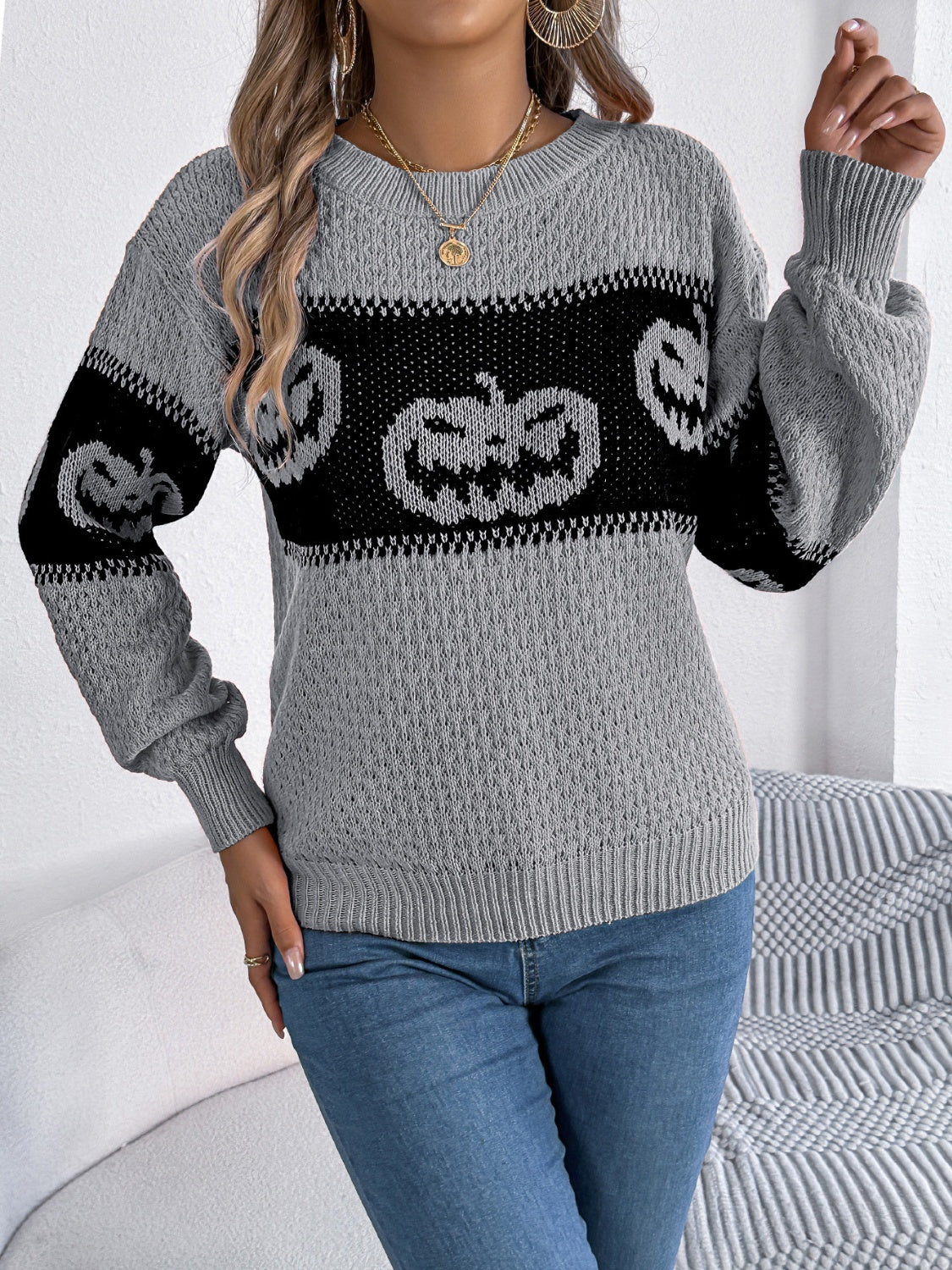 Gray acrylic knit sweater with jack-o'-lantern intarsia pattern, crew neck, and long sleeves.