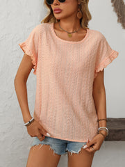 Peach eyelet knit blouse with ruffled short sleeves and a round neckline.