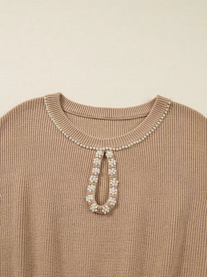 Ribbed knit sweater dress in tan with pearl-adorned keyhole neckline detail.