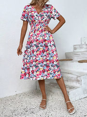 Vibrant floral print midi dress with V-neck, short sleeves, and elastic waist.