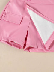 Pink faux leather skort with decorative pocket and button detail.