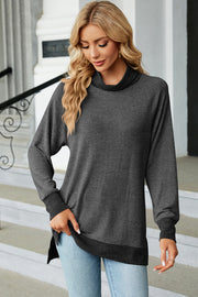 Colorblock raglan turtleneck tunic in dark gray with a contrasting hem and cuffs.