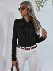 Black lace inset bow blouse with long sleeves.