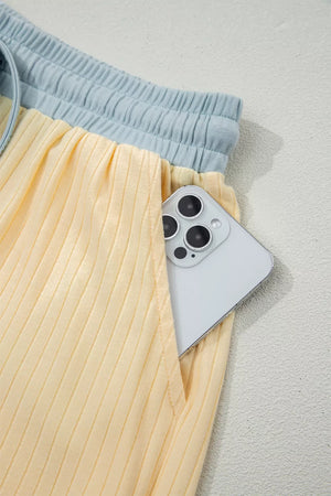 Color block ribbed cotton shorts set with light blue waistband and yellow shorts with pocket detail.