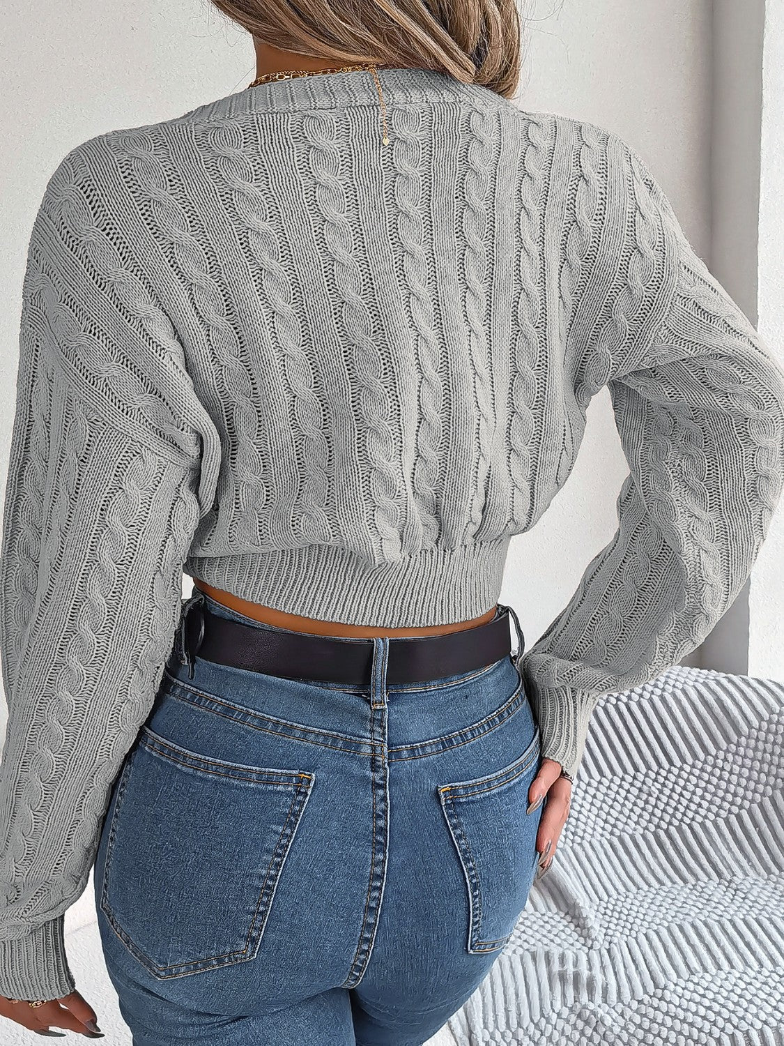Dark gray acrylic cable knit cropped sweater with twist front detail