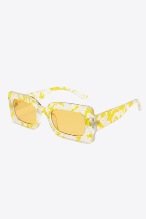 Rectangular frame sunglasses in Butter Yellow with swirl print and orange lenses.