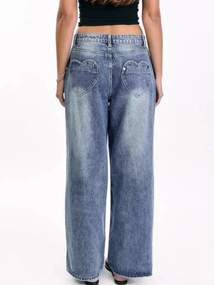 Wide-leg denim jeans with heart-shaped back pockets and a light wash.