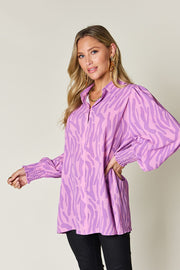 Lavender zebra print blouse with shirred cuffs and puff sleeves.