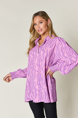 Lavender zebra print blouse with shirred cuffs and puff sleeves.