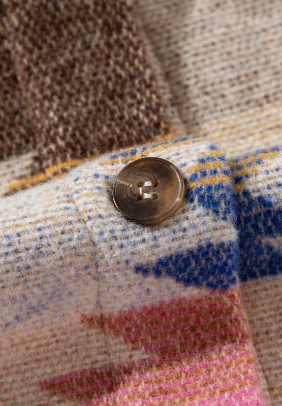 Beige Southwestern print shirt jacket with button detail and textured fabric.