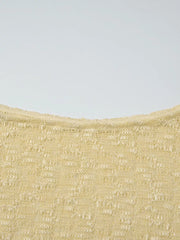 Yellow sheer one-shoulder cropped cardigan with intricate knit pattern