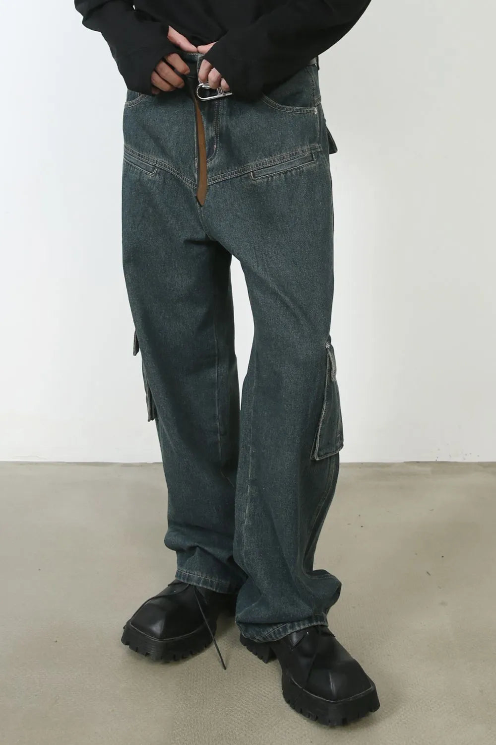 Panelled dark denim cargo pants with zip pockets and a relaxed fit.