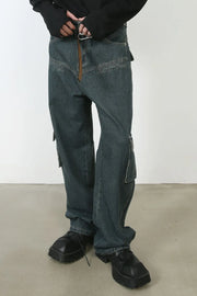 Panelled dark denim cargo pants with zip pockets and a relaxed fit.