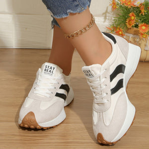 Lace up round toe sneakers in gray/white with black stripes and chunky sole.