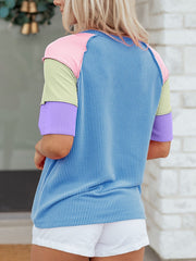 Color block patchwork henley t-shirt with blue stripes and pastel sleeves.