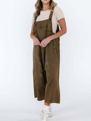Brown ripped relaxed fit denim overalls with adjustable straps.