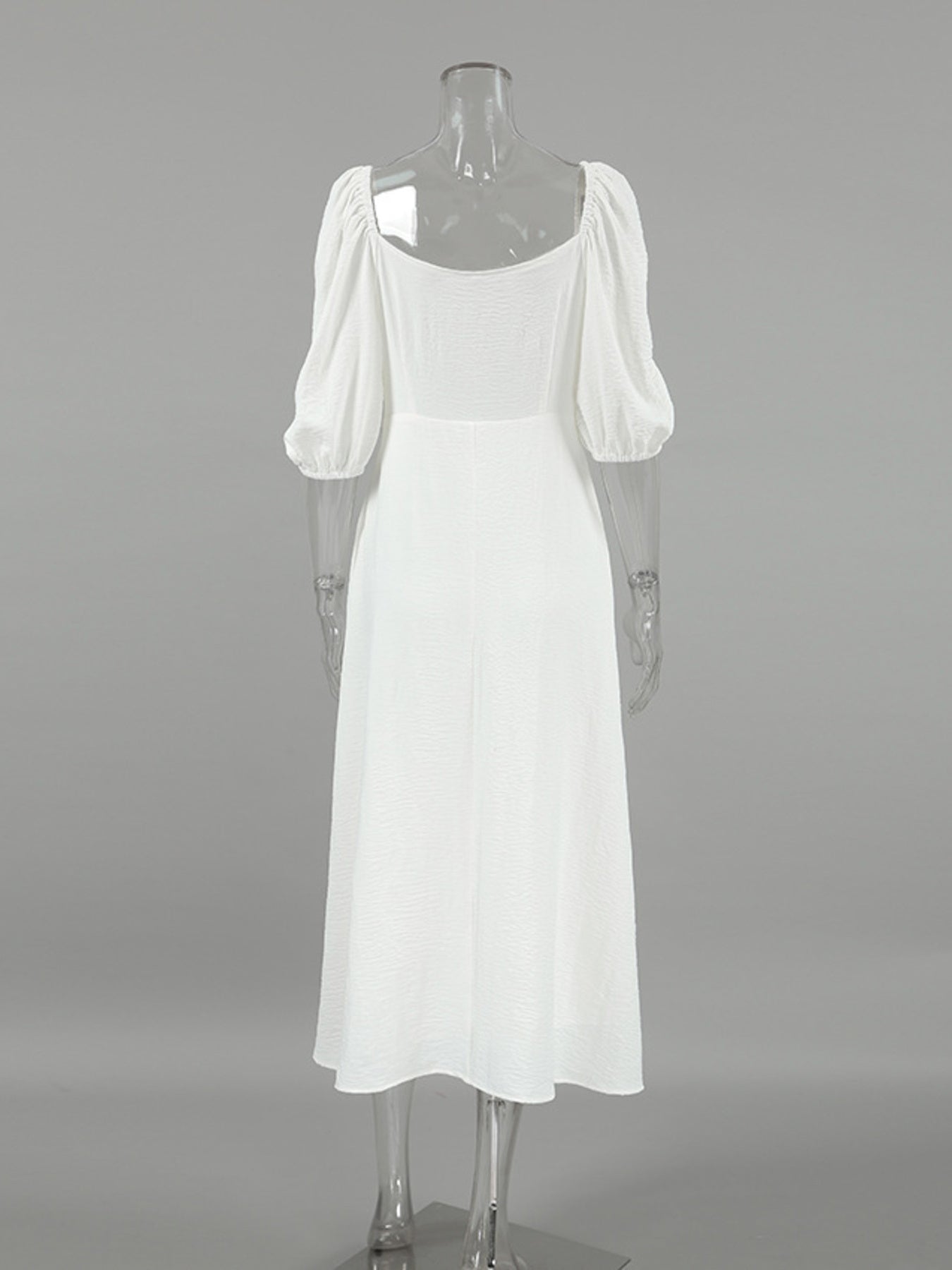White midi dress with puff sleeves and square neckline, textured fabric, a-line cut