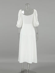 White midi dress with puff sleeves and square neckline, textured fabric, a-line cut