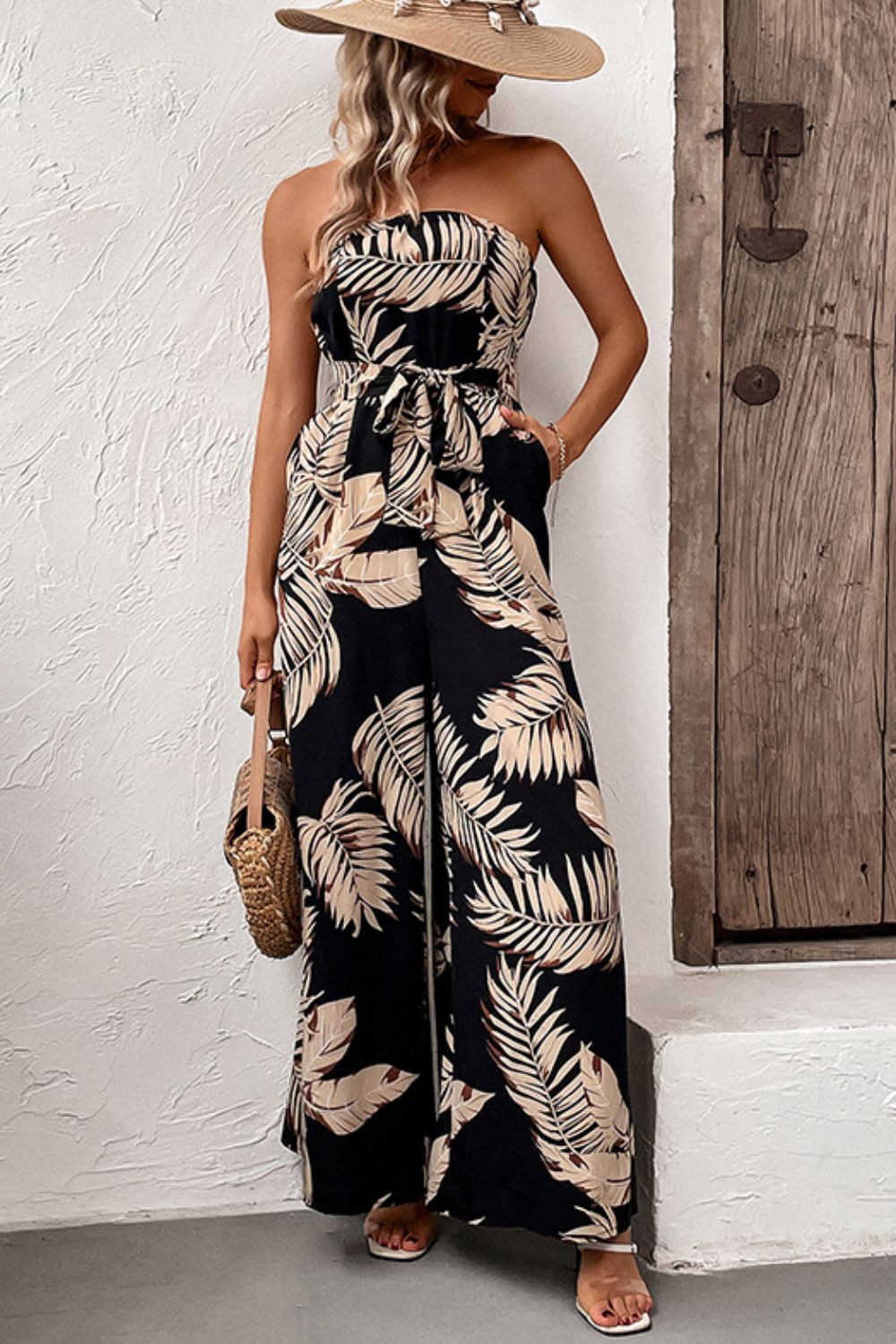 Black tropical leaf print bandeau jumpsuit with tie waist and wide legs