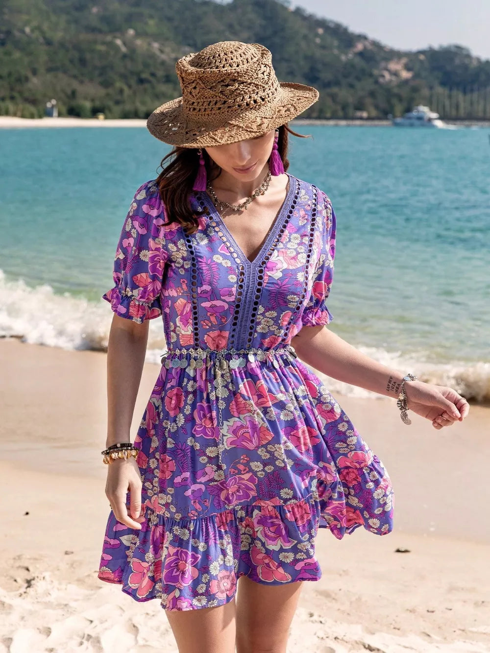 Vibrant floral eyelet mini dress with V-neck, short ruffled sleeves, and tiered skirt.