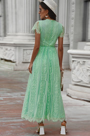 Midi dress in mid green lace with short flutter sleeves and scalloped hem.