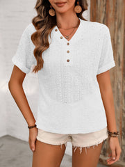 White eyelet henley blouse with short sleeves and button placket.