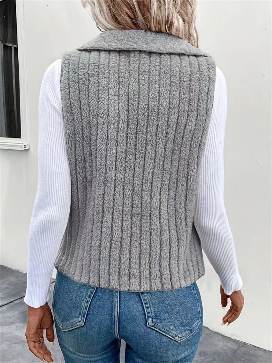 Textured teddy collarless vest in gray with vertical ribbing detail.