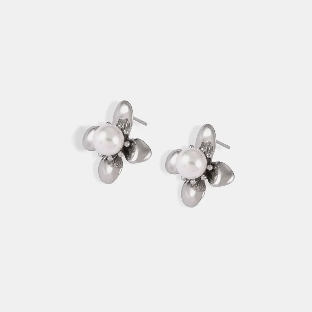 Silver petal pearl stud earrings with a floral design.
