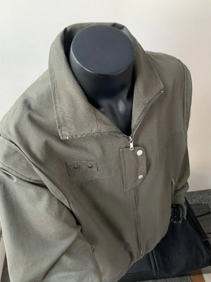 Green casual bomber jacket with zip closure and buttoned flap pockets.