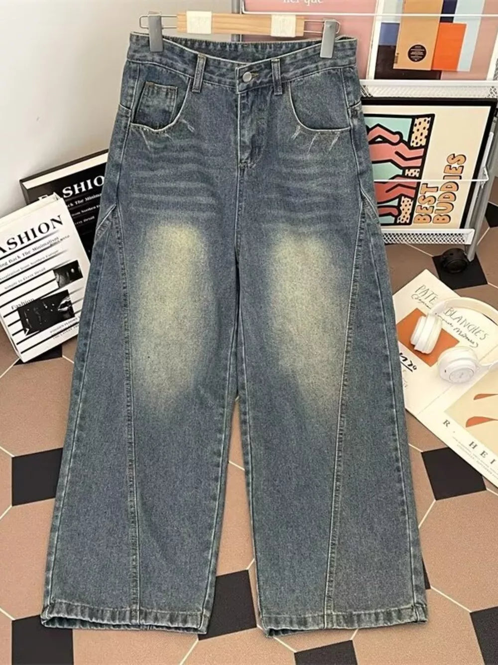Men's wide-leg jeans in vintage wash denim with a relaxed fit and faded details.