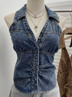 Blue denim halter top with collar, button front, and gathered waist detail.
