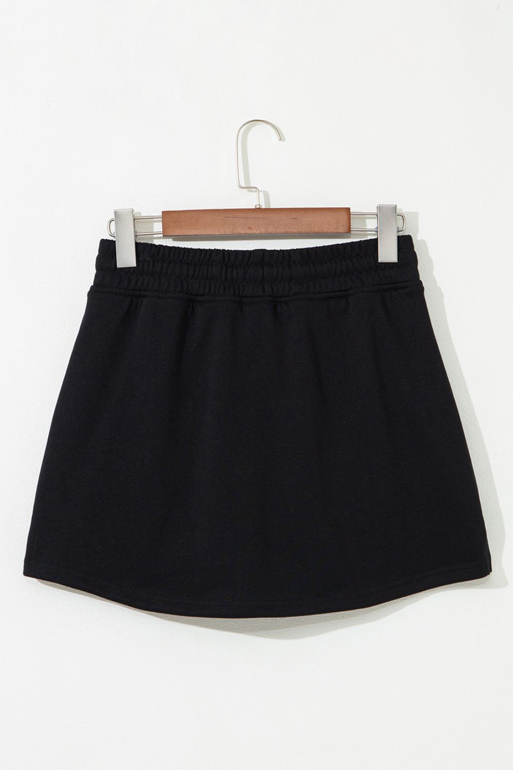 Black French terry skort with drawstring waist and pockets.