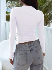 White long sleeve slim fit t-shirt with ruched sides, paired with light wash jeans.