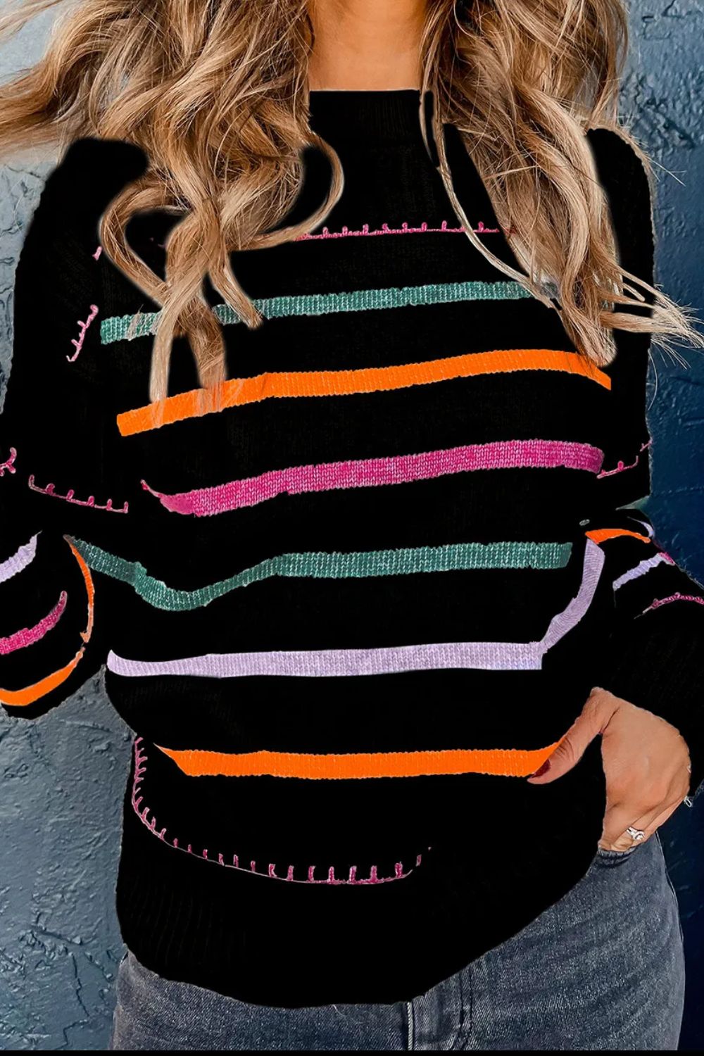 Black ribbed knit pullover sweater with rainbow stripes and contrast stitching detail.
