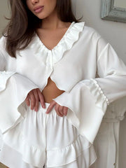 White ruffled V-neck pajama set with shorts and bell sleeves.