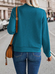 French blue quilted bomber jacket with zip closure, long sleeves, and a stand-up collar.