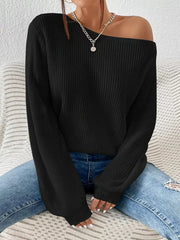 Black asymmetrical knit sweater with off-shoulder neckline and long sleeves.