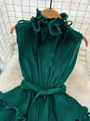 Dark green pleated midi dress with ruffled neckline and belted waist.
