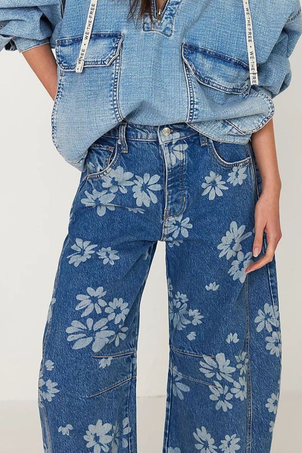 Floral print balloon jeans in medium wash denim with a wide leg.