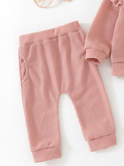Toddler pink waffle knit pants with pockets and matching long sleeve top detail