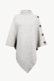 Light gray knit poncho with turtleneck and button detail on shoulder.