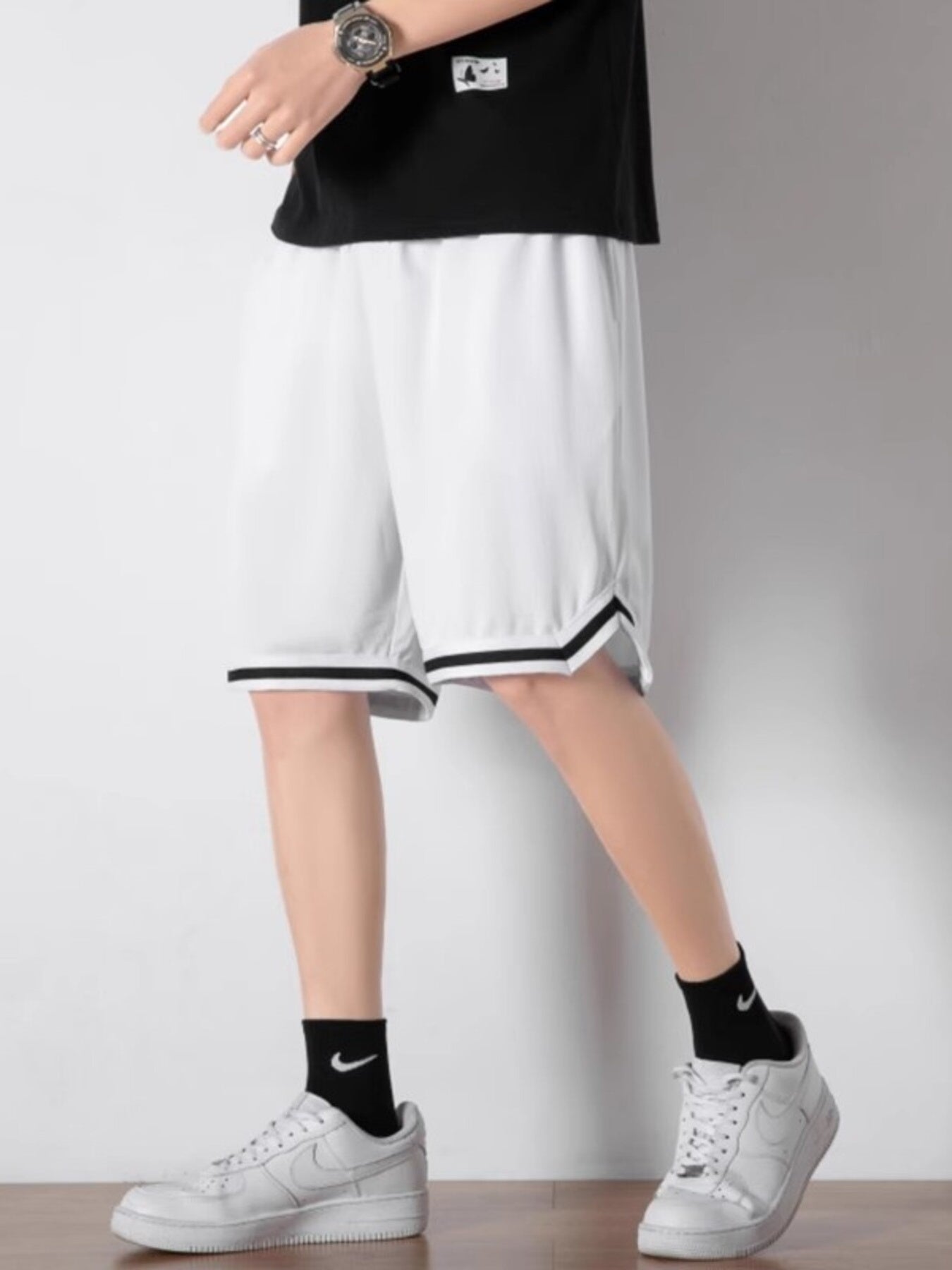 Men's white athletic shorts with black trim detail and drawstring waist.
