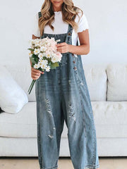 Ripped relaxed fit denim overalls in light blue with adjustable straps and button closure.