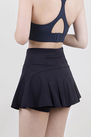 Dark blue sculpted flared active skort with built-in shorts and pleated skirt detail