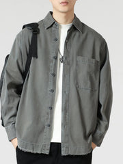 Grey oversized button-up long-sleeve shirt with chest pocket and frayed hem